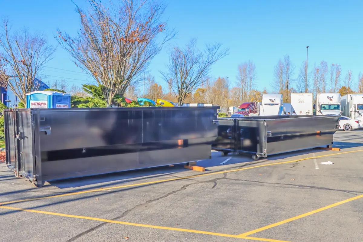 Professional dumpster rental service with roll-off container on residential driveway in Hammonton